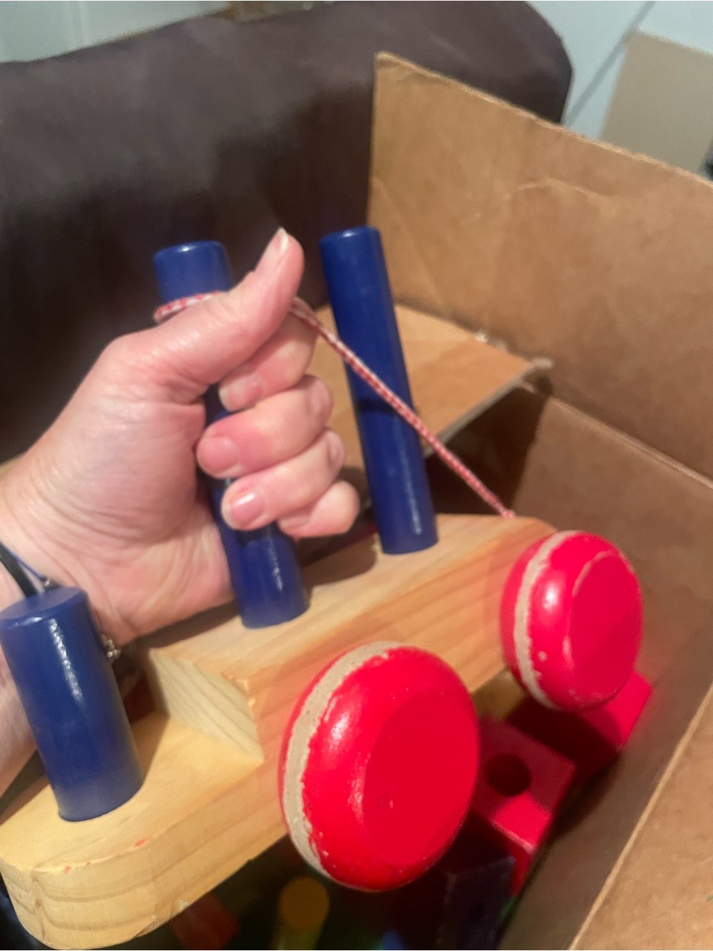 Wooden Pull-Along Toy with Red Wheels and Blue Handles